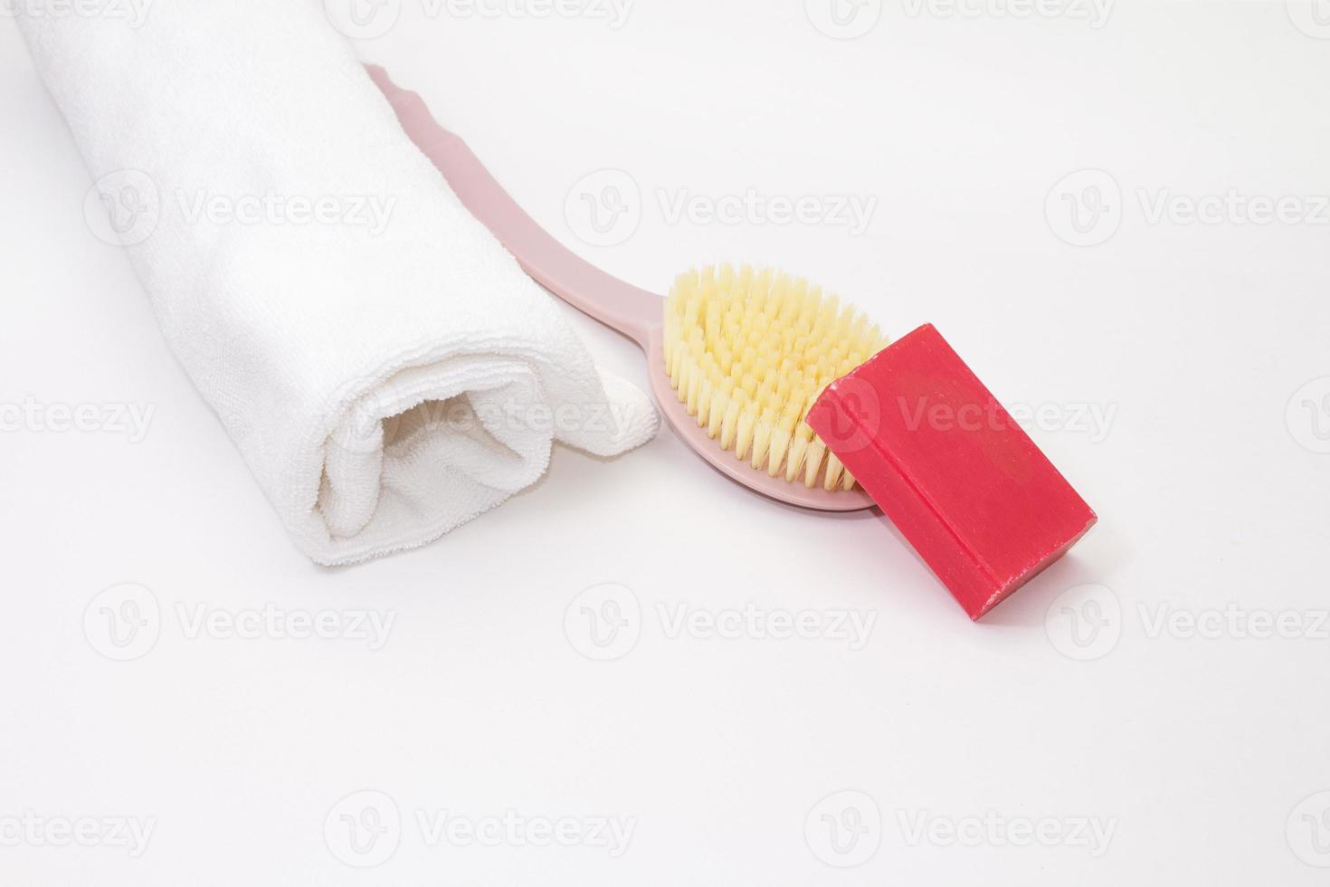 arrollado arriba toalla con lavar cepillo y rosado jabón en blanco aislado antecedentes. limpieza, cuidado. Copiar espacio foto