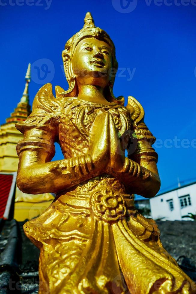 Buddhist sculptures at a temple in Bangkok, Thailand photo