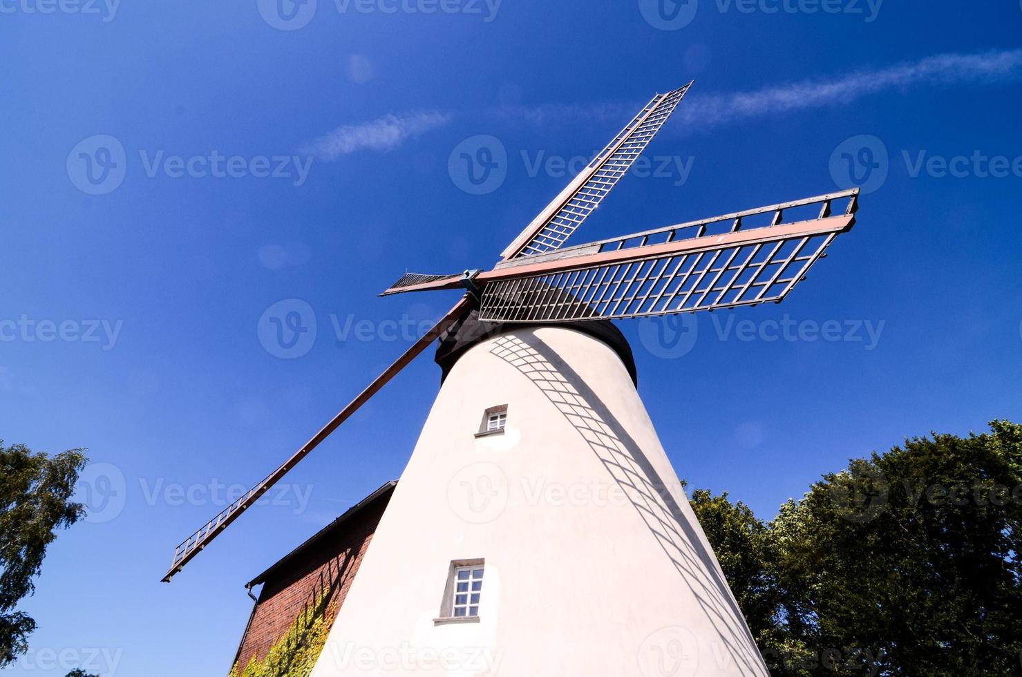 Traditional windmill under blue sky photo