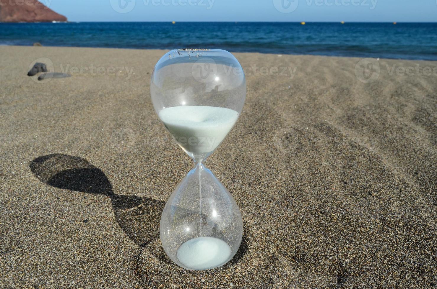 Hourglass in the sand photo