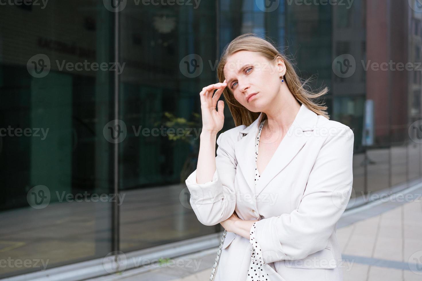 Focused professional thinking. Young caucasian business woman in photo