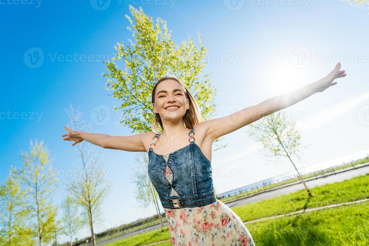 Beauty girl outdoors enjoys nature. Beautiful model in long dress having fun photo
