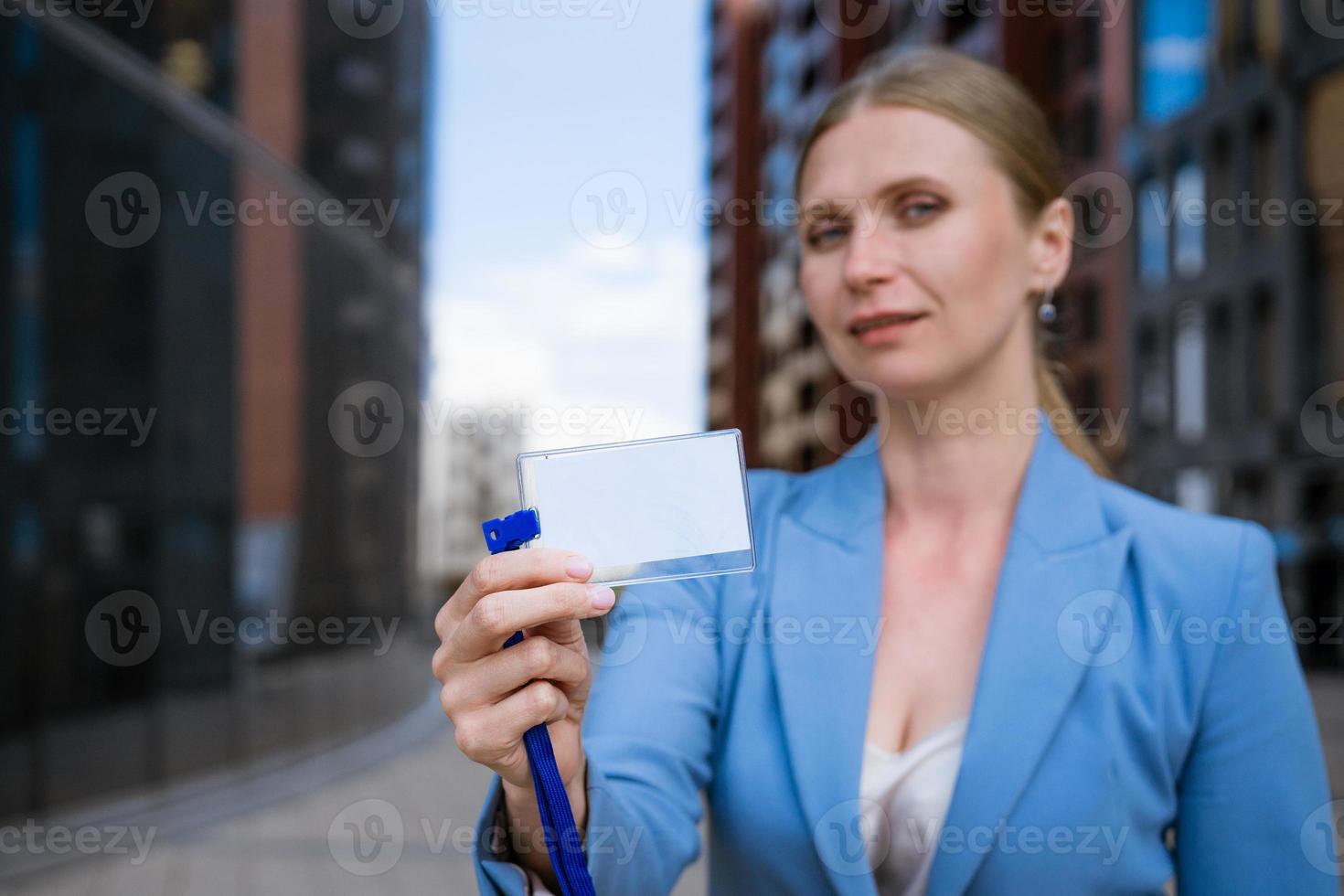 Business woman holding badge in hand photo