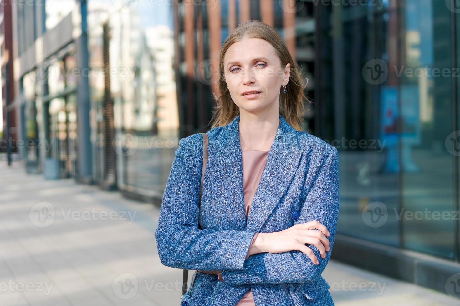 Happy business woman with professional appearance smiling confidently in city photo