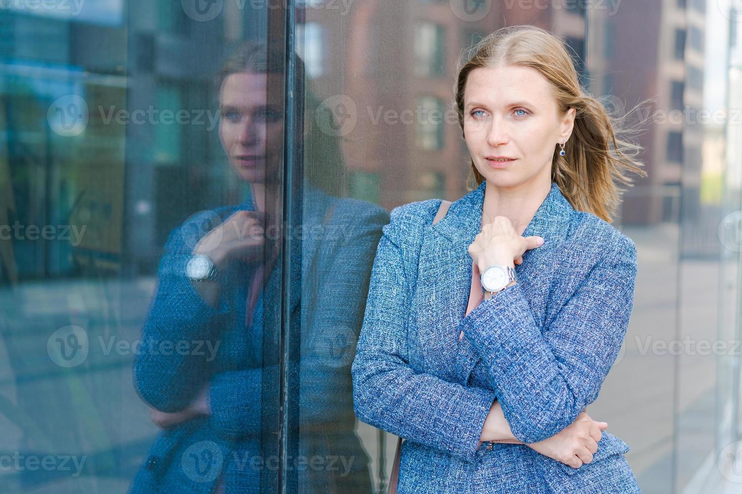 Confident successful smiling business woman entrepreneur in suit standing photo