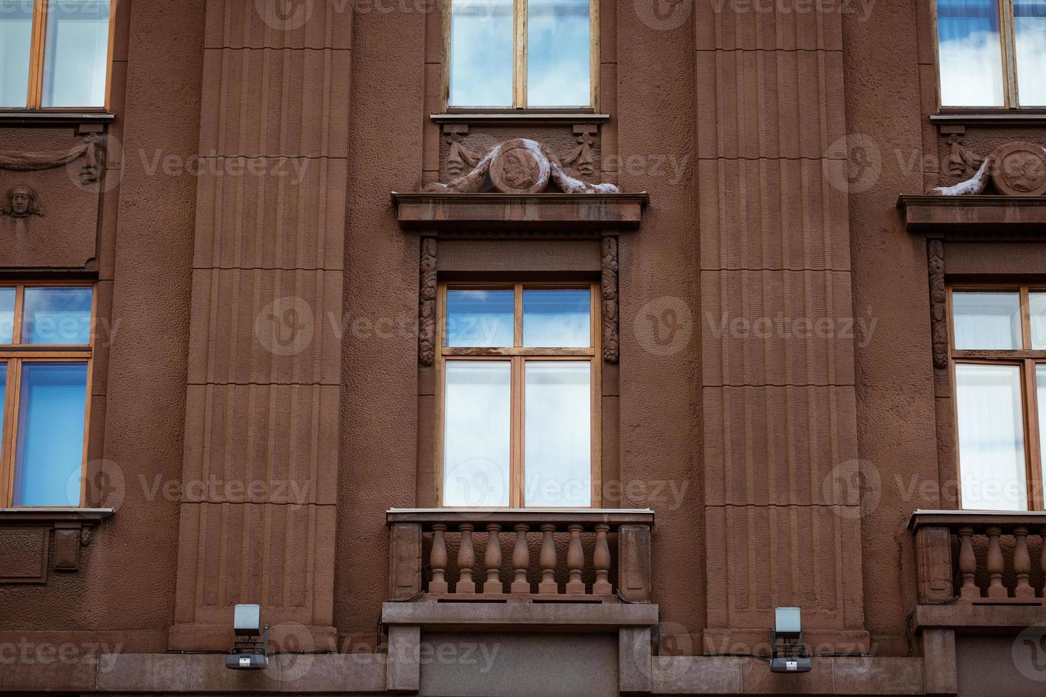 facade of a building with windows, the sky is reflected in the windows photo