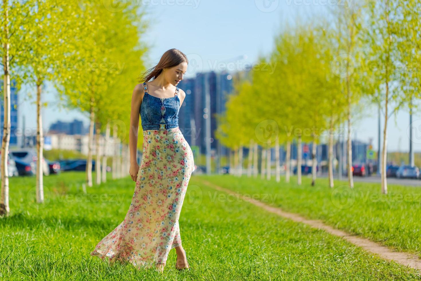 Portrait happy beautiful young woman relaxing in park in long dress. Joyful photo