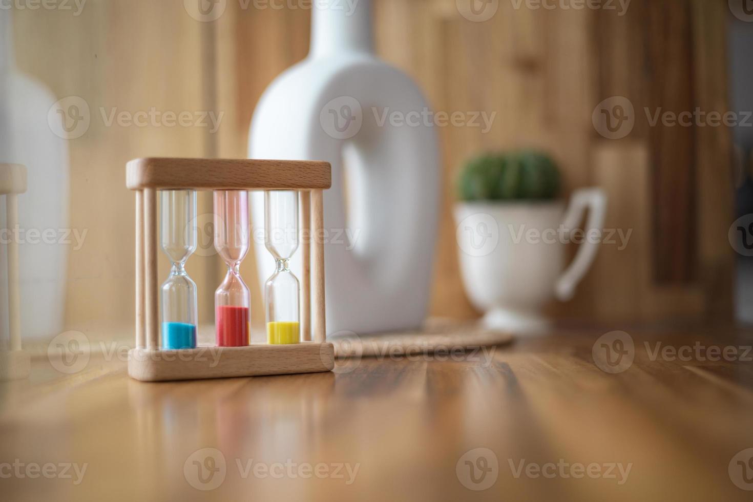 Colorful hourglasses with blurred background cute concept photo