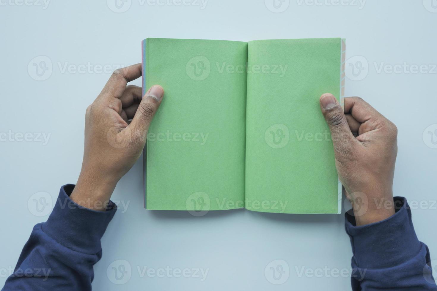 top view of an's hand turning a pager of a diary photo