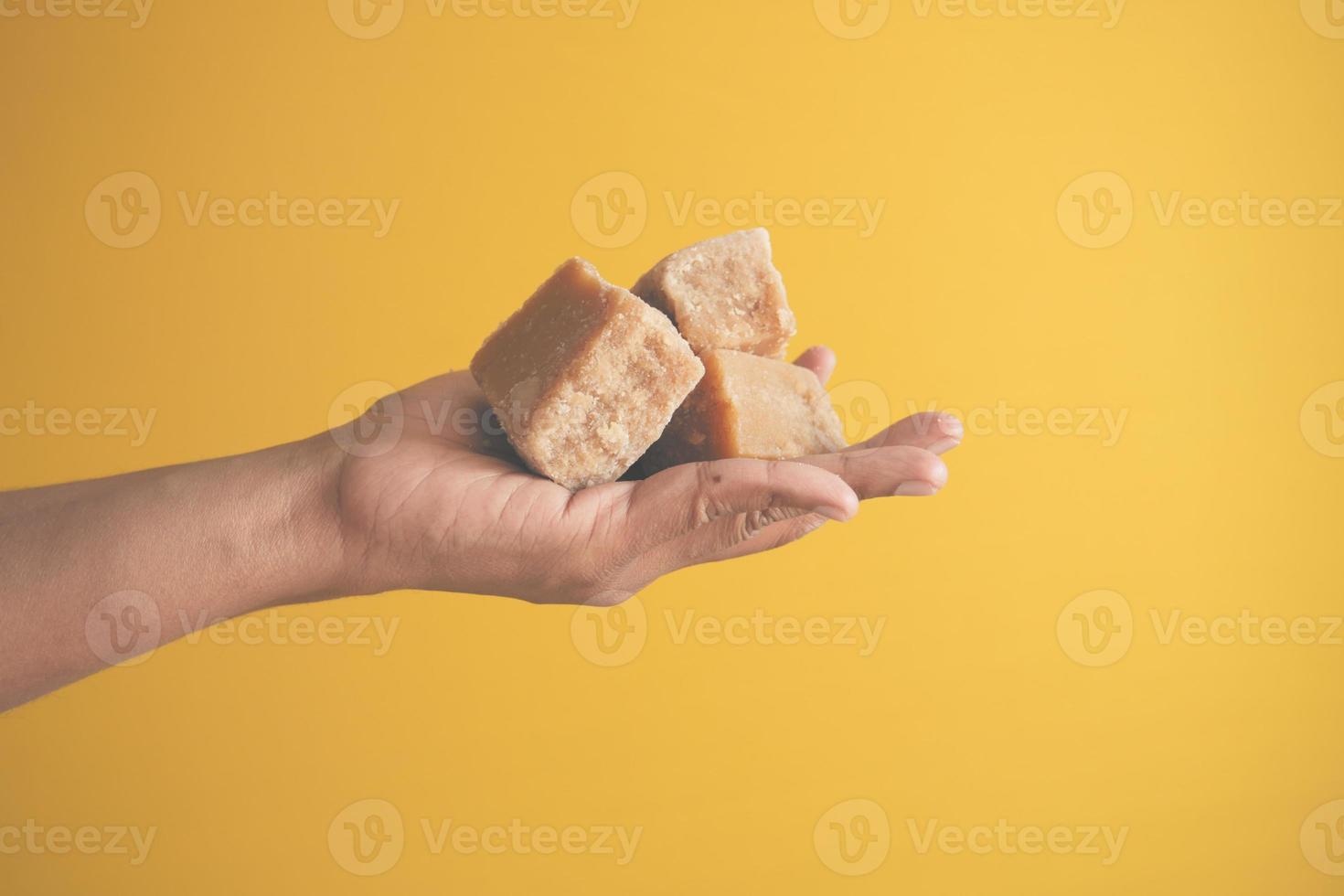 Jaggery traditional cane sugar cube on hand photo