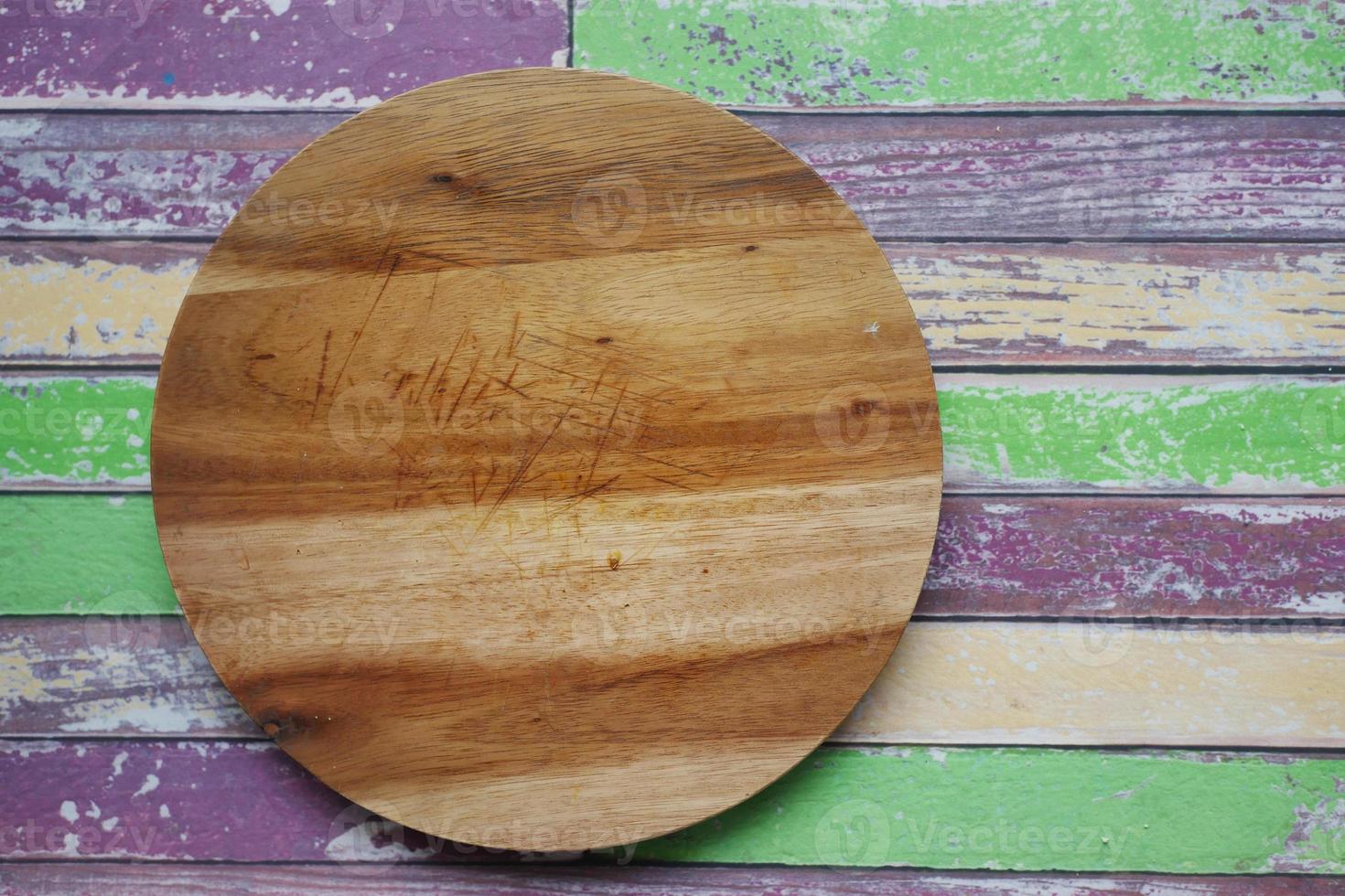 wooden chopping board on black background top down photo