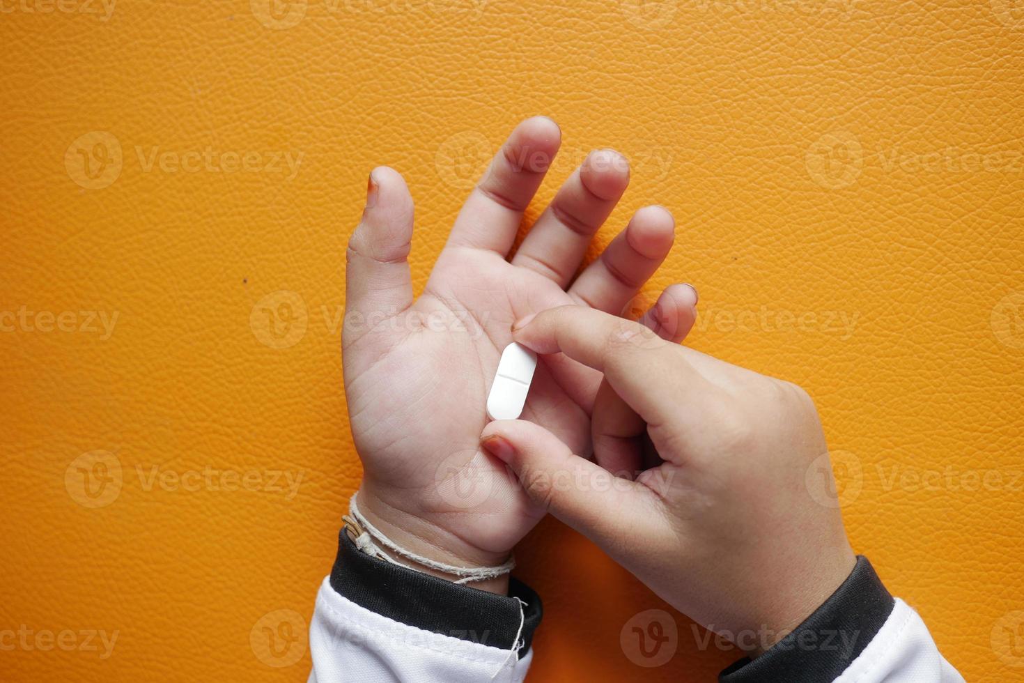 close up of medical pills on palm of child hand photo