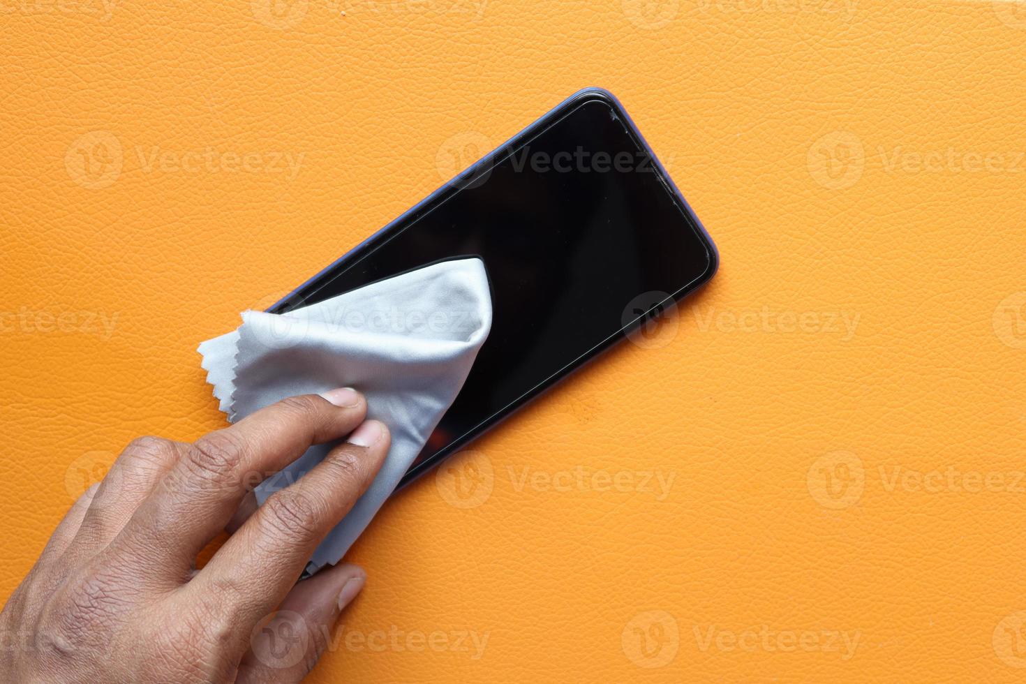 cleaning mobile phone display for preventing virus photo