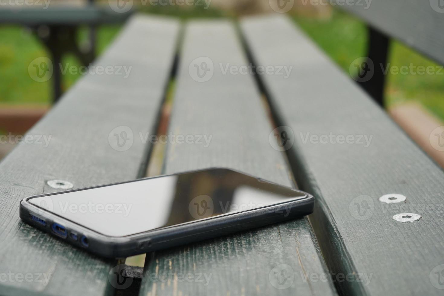 olvide el teléfono inteligente en un banco del parque, perdió el teléfono inteligente foto