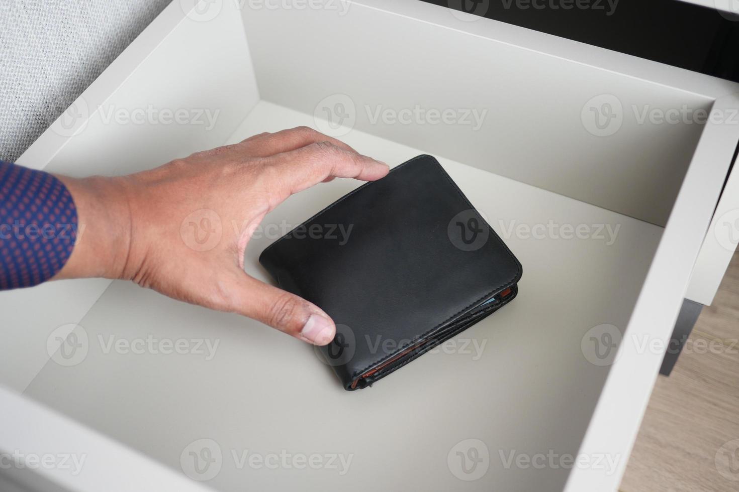 men stealing wallet from a drawer photo