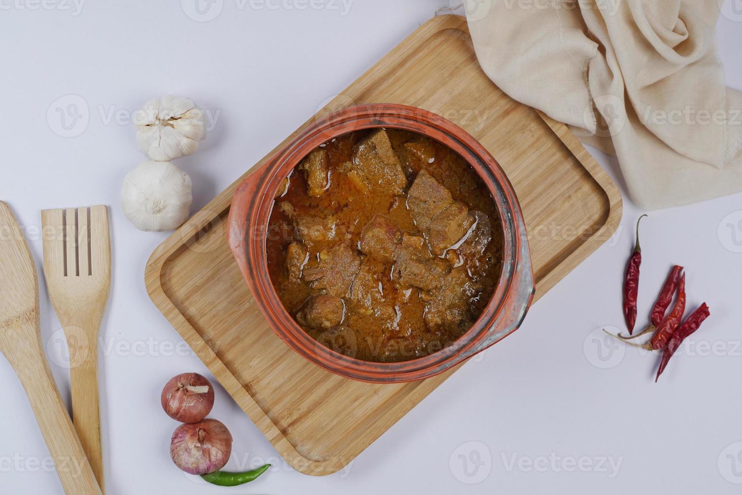 traditional Indian curry lamb masala in a bowl on table photo
