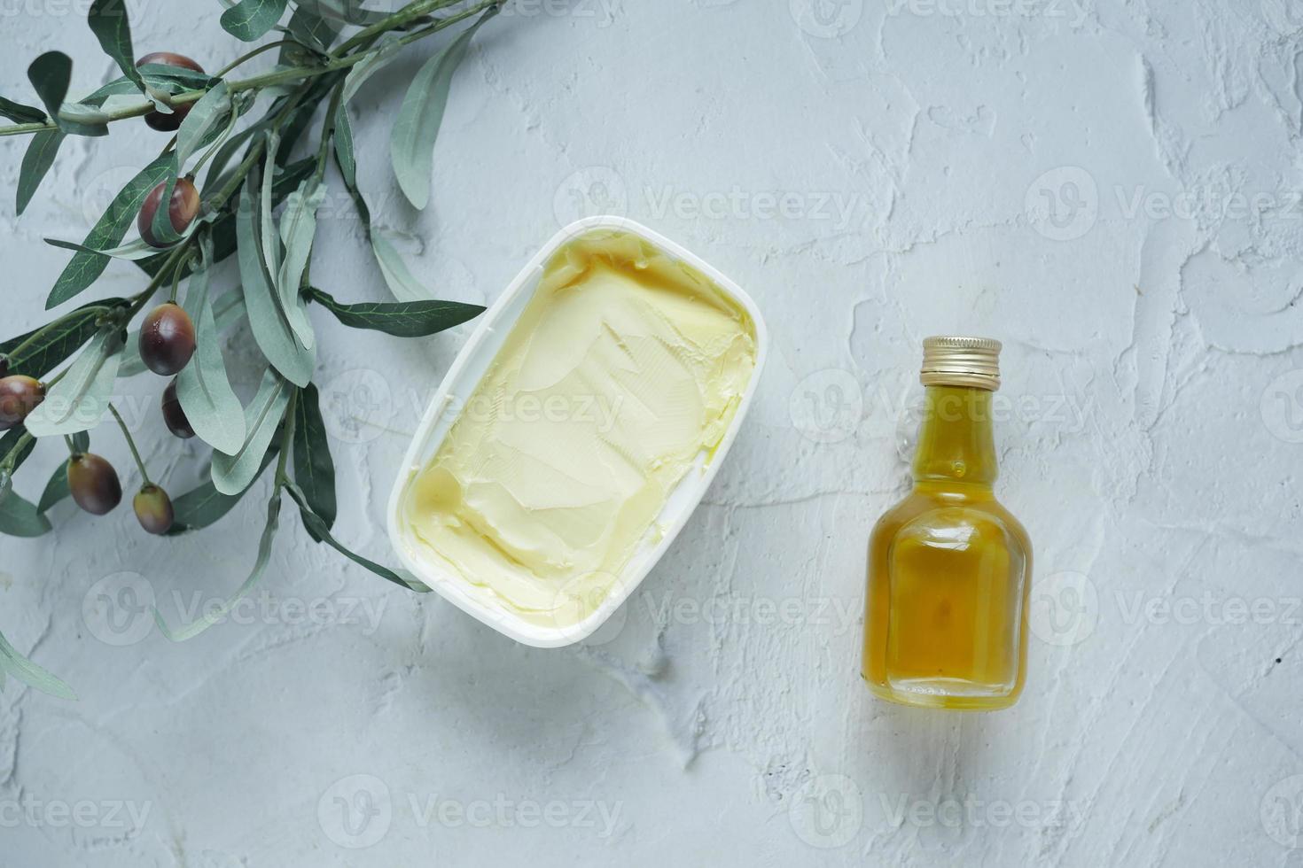 fresh butter in a container with bread on white background photo