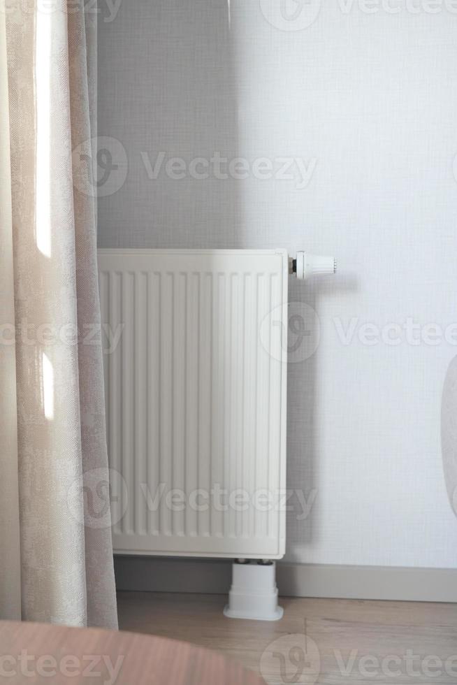 heating radiator under window in the room photo