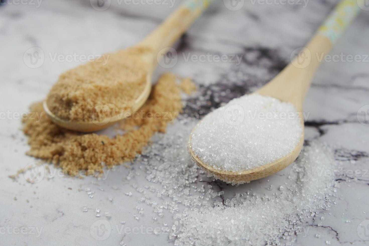 comparing white and brown sugar on table photo