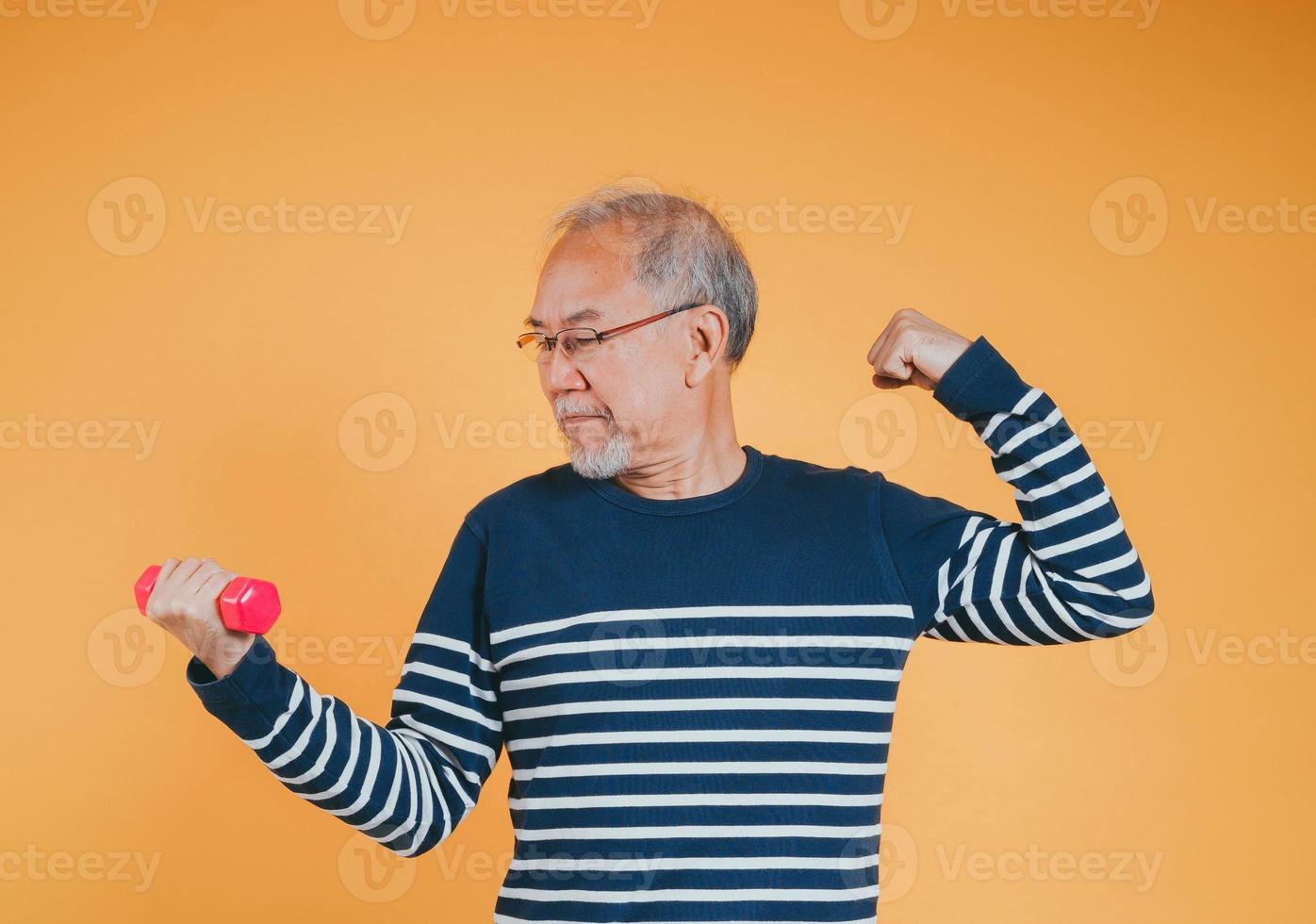 Senior male with dumbbell for exercise active lifestyle in retirement life health care on color background. photo