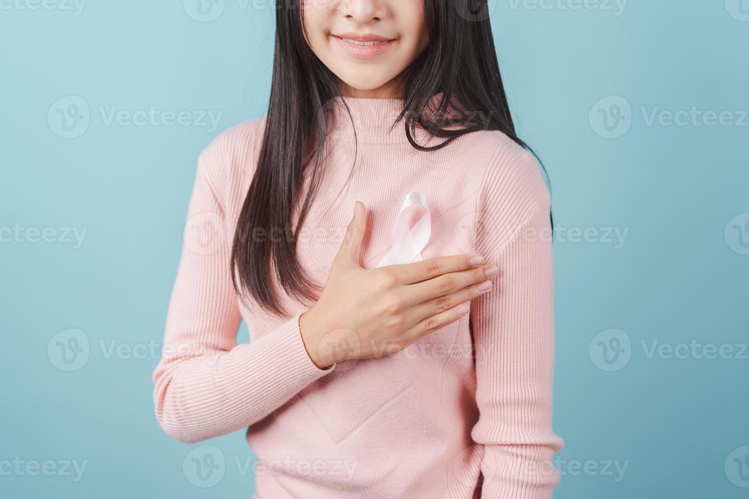 happy woman showing pink ribbon, Breast cancer awareness, world cancer day, national cancer survivor day in february concept. photo