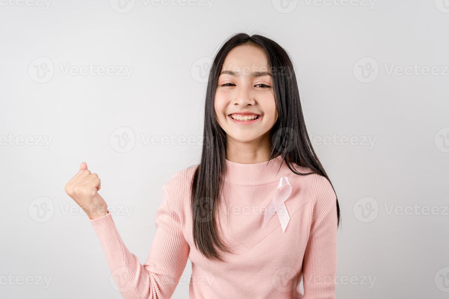 happy woman showing pink ribbon, Breast cancer awareness, world cancer day, national cancer survivor day in february concept. photo