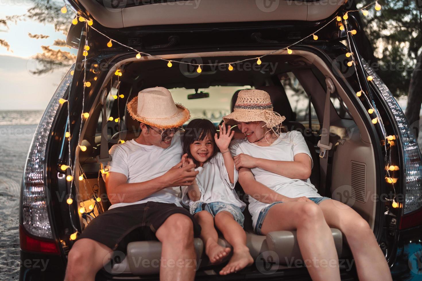 Happy Family with car travel and camping road trip. summer vacation in car in the sunset, Dad, mom and daughter happy traveling enjoy together driving in holidays, people lifestyle ride by automobile. photo