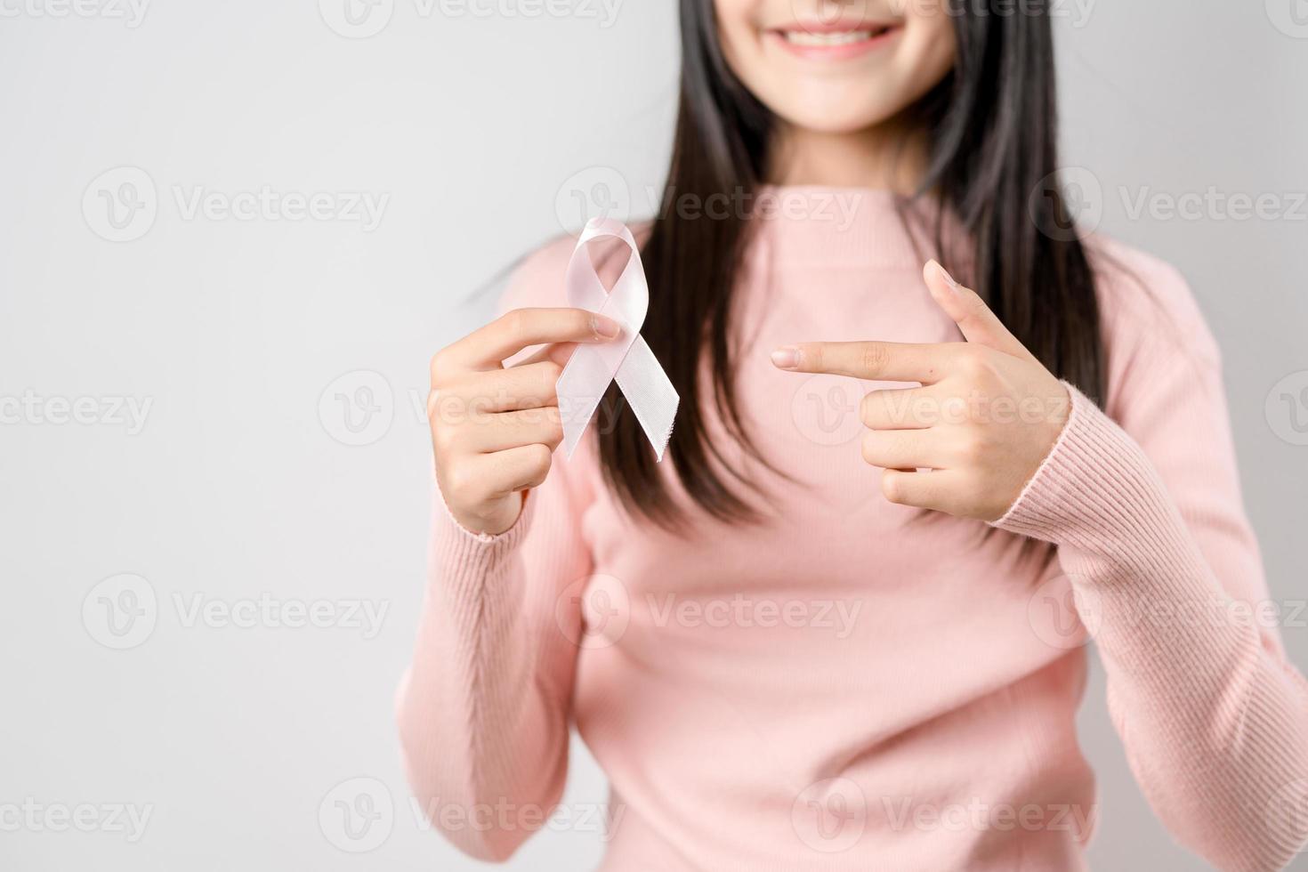 happy woman showing pink ribbons, Breast cancer awareness, world cancer day, national cancer survivor day in february concept. photo