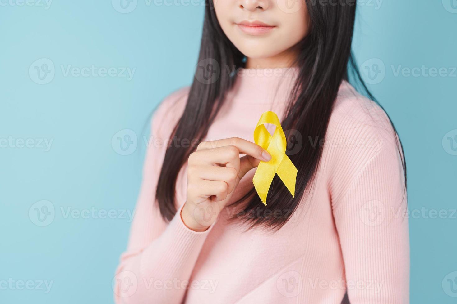 happy woman holding yellow ribbon, september, suicide prevention day, childhood, sarcoma, bone and bladder cancer Awareness month, health care support people and world cancer day concept photo