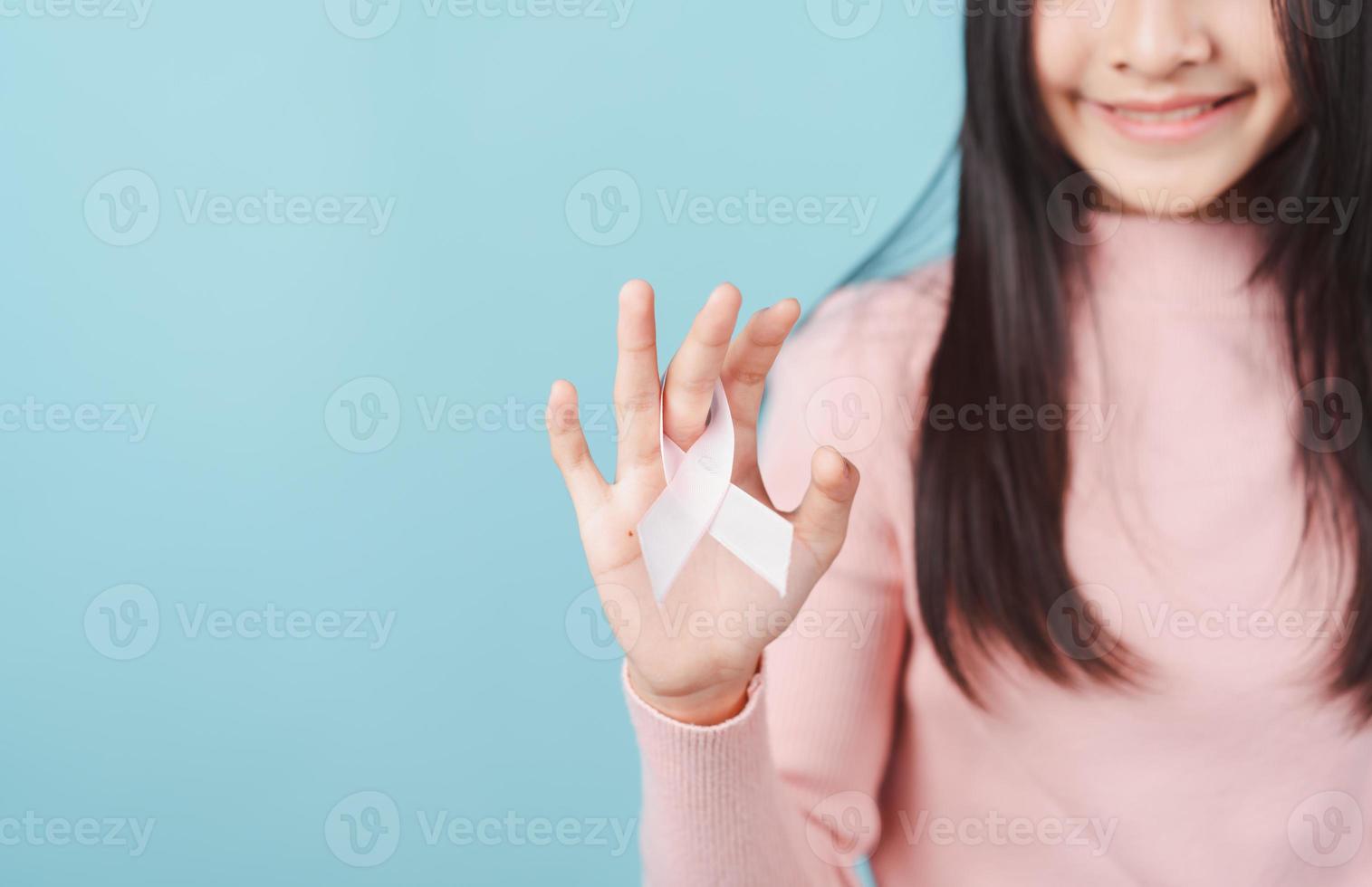 happy woman showing pink ribbon, Breast cancer awareness, world cancer day, national cancer survivor day in february concept. photo