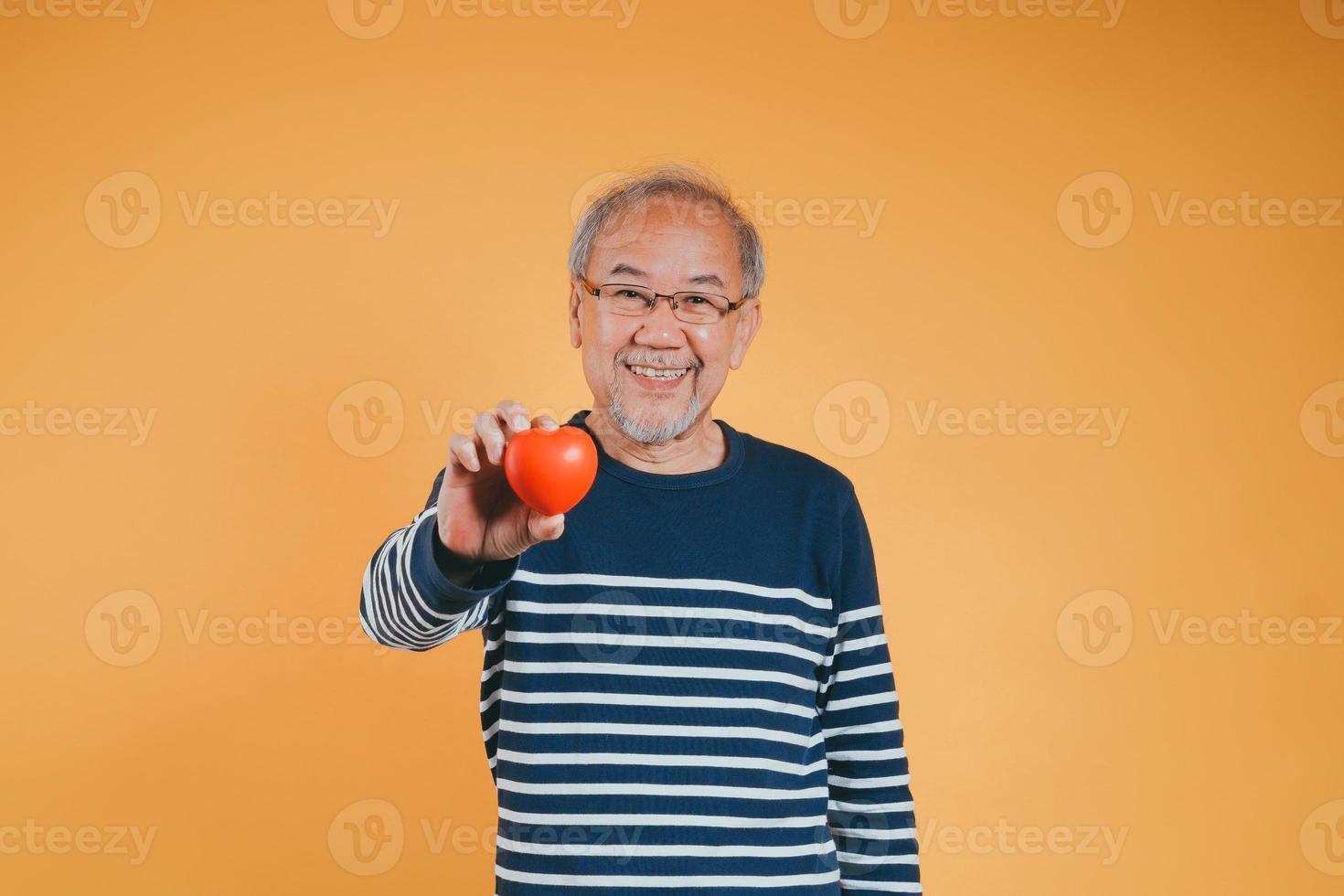 Senior male holding heart love emotion insurance concept on color background. photo
