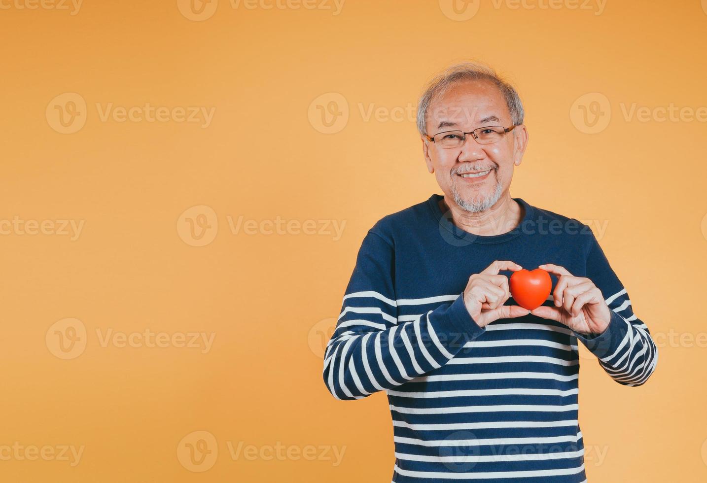 Senior male holding heart love emotion insurance concept on color background. photo