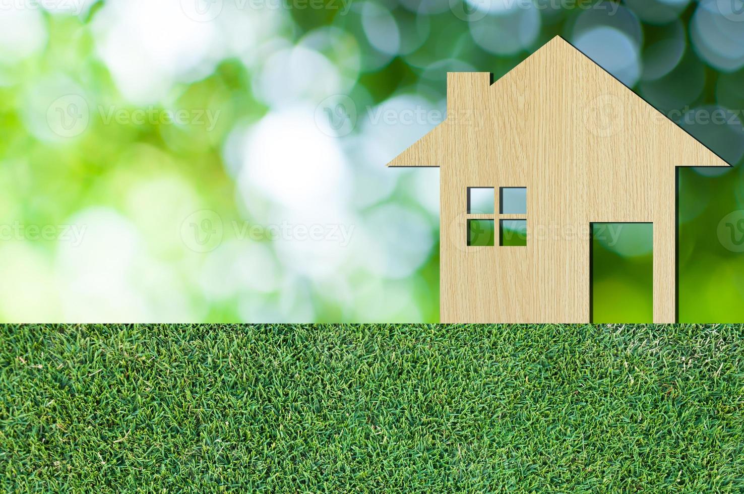 house icon from  wooden on grass texture nature background as symbol of mortgage,Dream house on nature background and space for your text photo