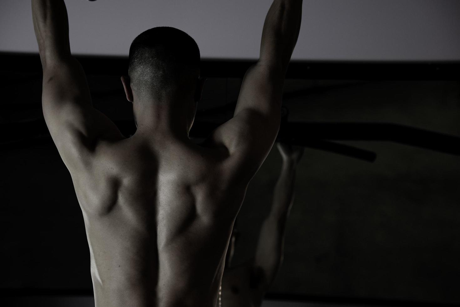 Sexy body of muscular young soldier Asian man in gym. Concept of health care, exercise fitness, Strong muscle mass, body enhancement, fat reduction for men's health supplement product presentation. photo