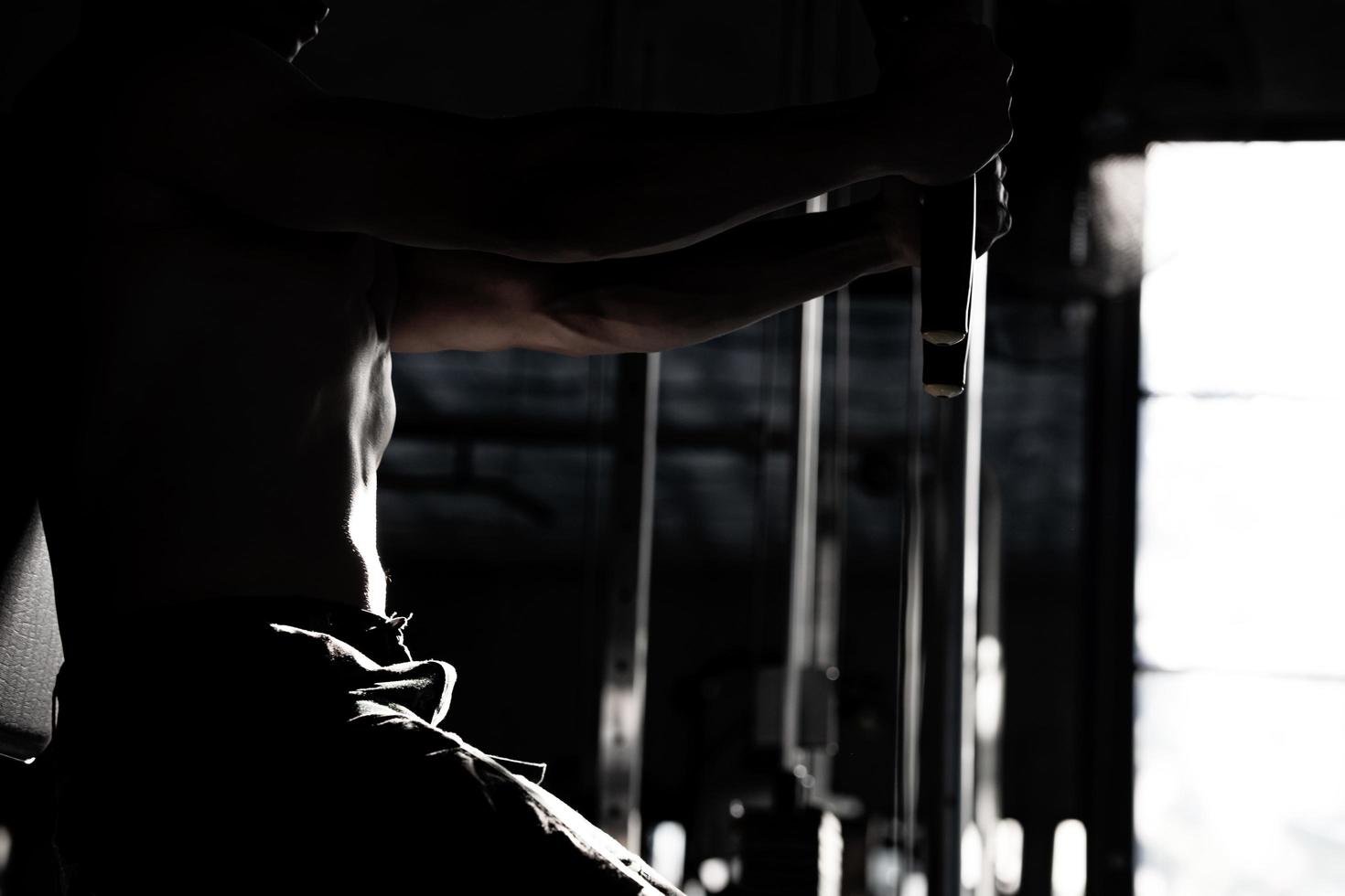 Sexy body of muscular young soldier Asian man in gym. Concept of health care, exercise fitness, Strong muscle mass, body enhancement, fat reduction for men's health supplement product presentation. photo