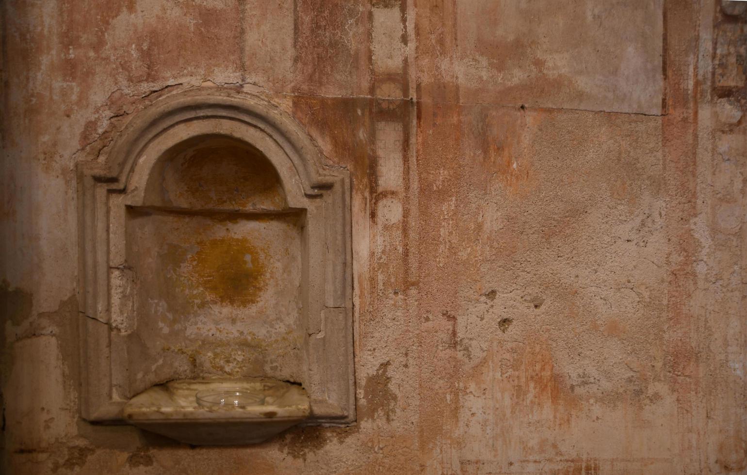 The old baptismal font of a church photo