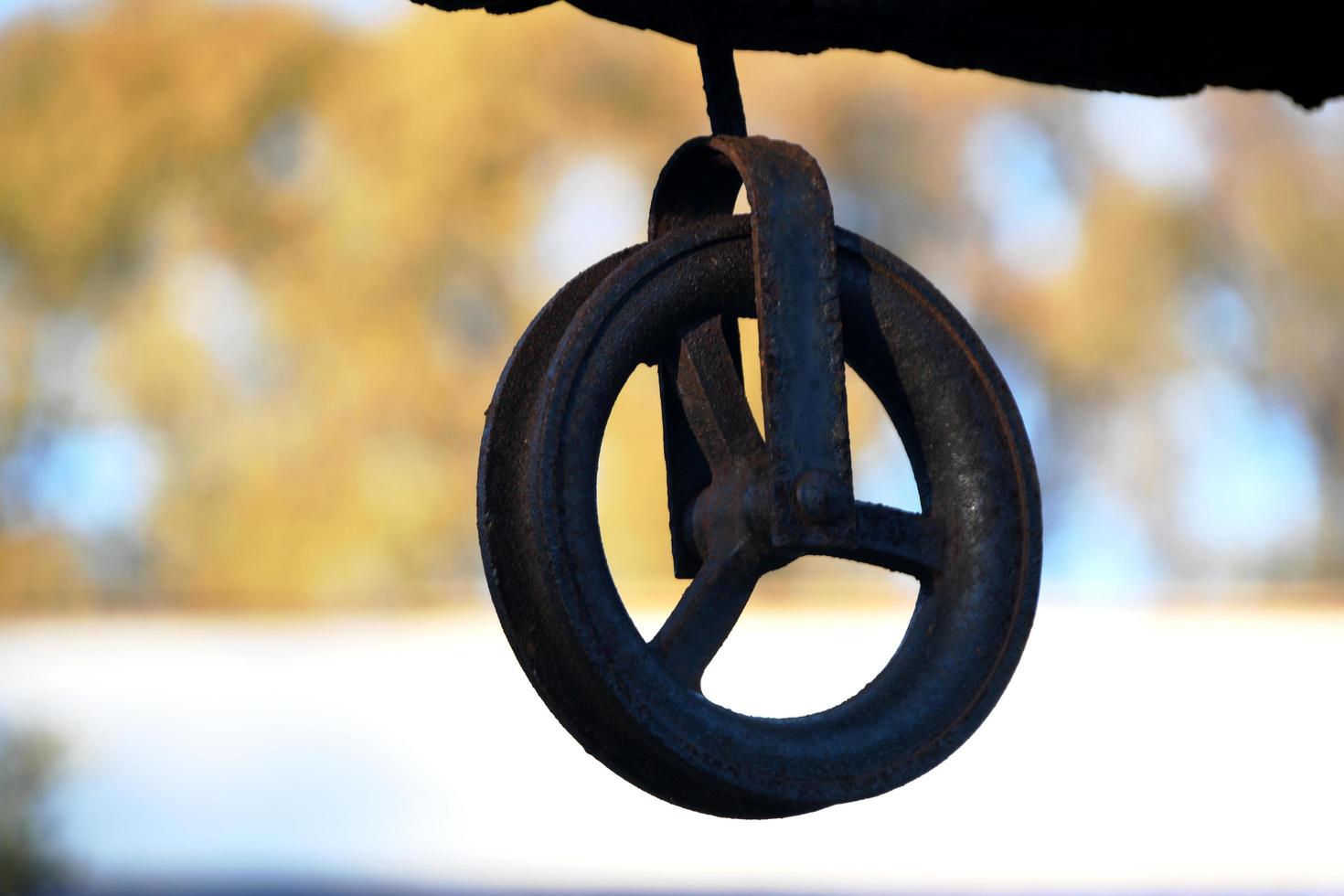 Old iron pulley from a well photo