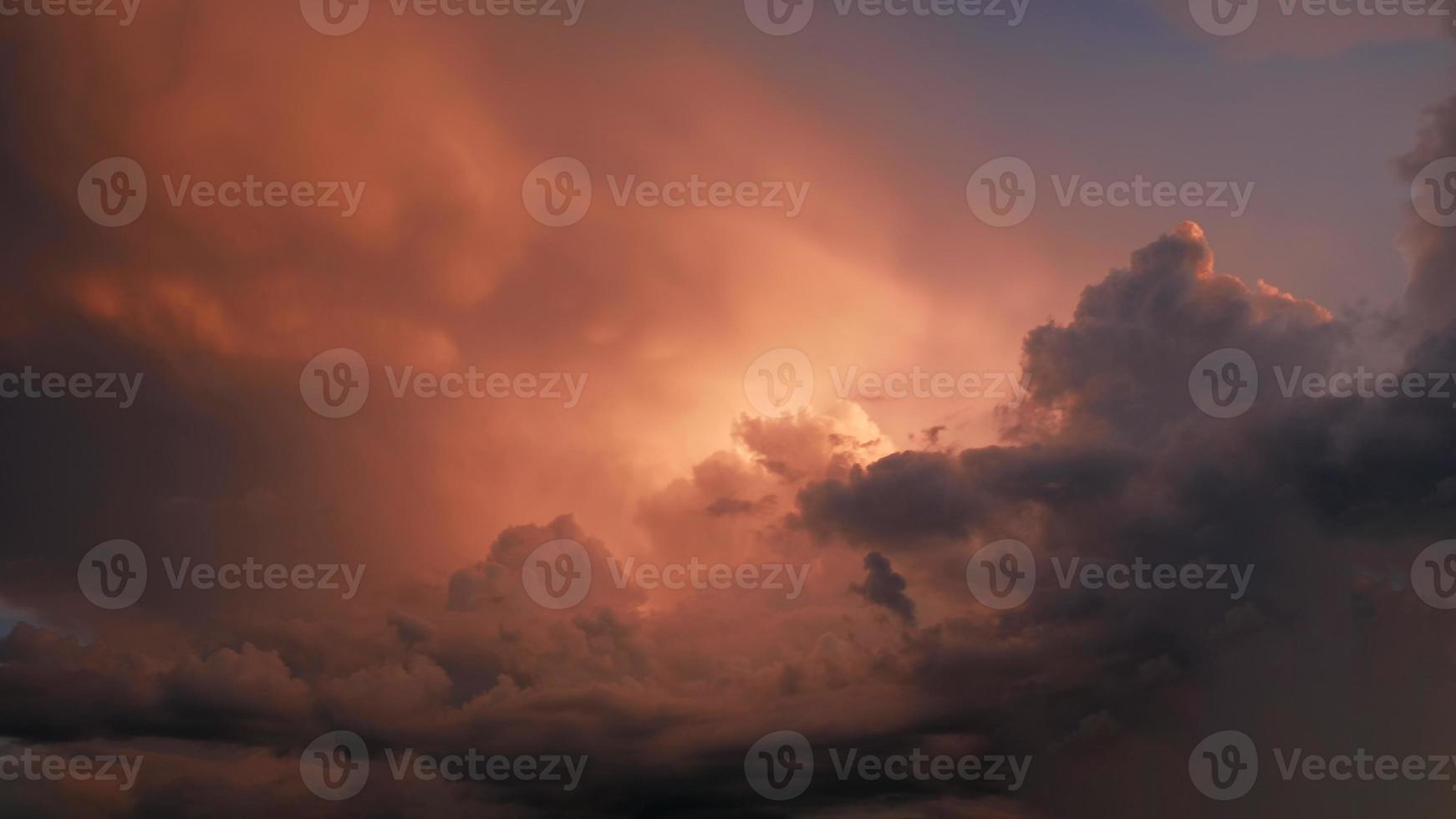 Dramatic sky. Purple and pink sky with clouds of sunset or sunrise background. Purple sky with clouds. Twilight colorful skies. Air and fluffy clouds. photo