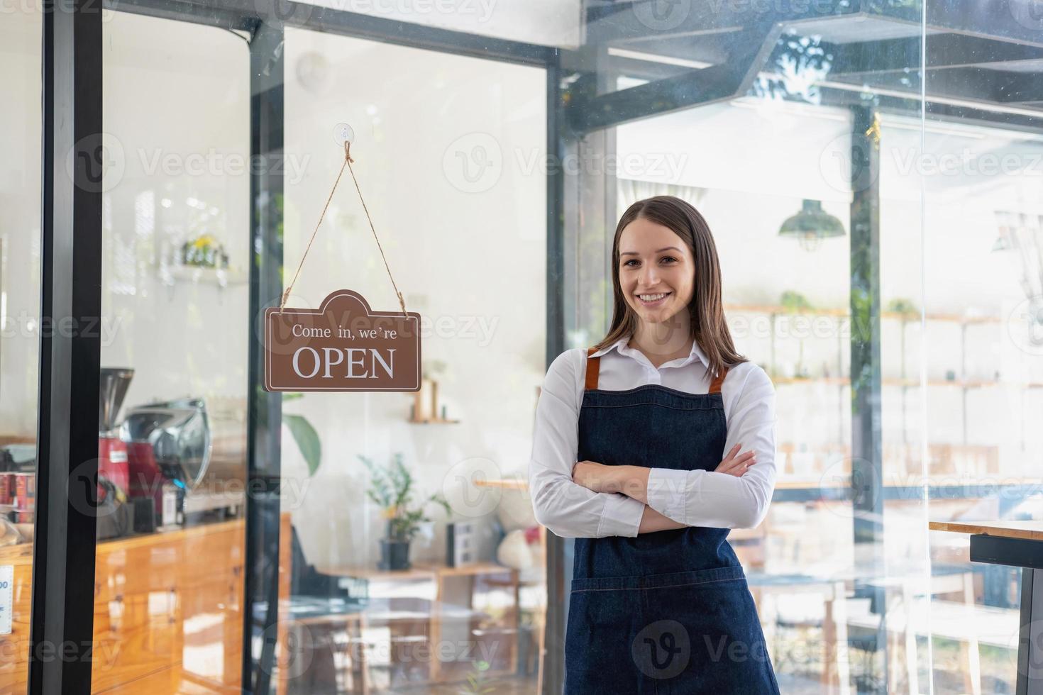 Portrait of a woman, a coffee shop business owner smiling beautifully and opening a coffee shop that is her own business, Small business concept. photo