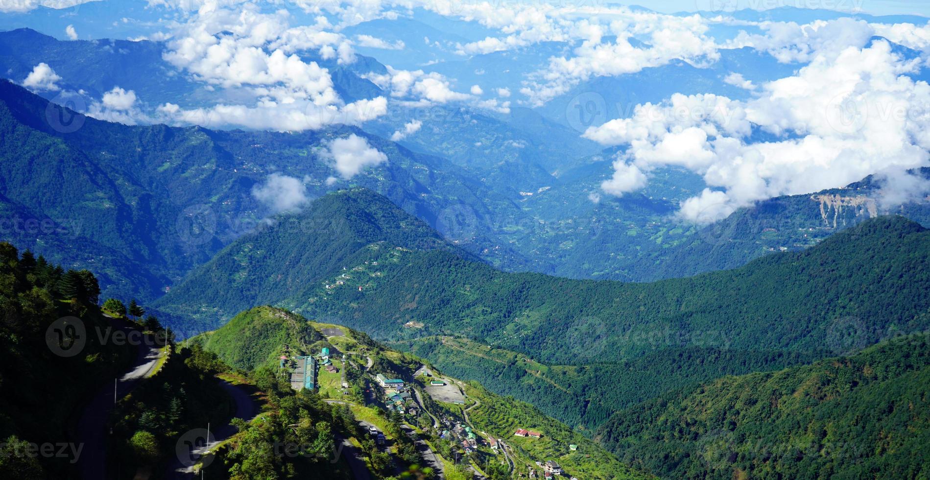 Landscape of Green Himalayan Range of Zuluk Village with Blue Sky and White Clouds from top of Silk Route Sikkim photo