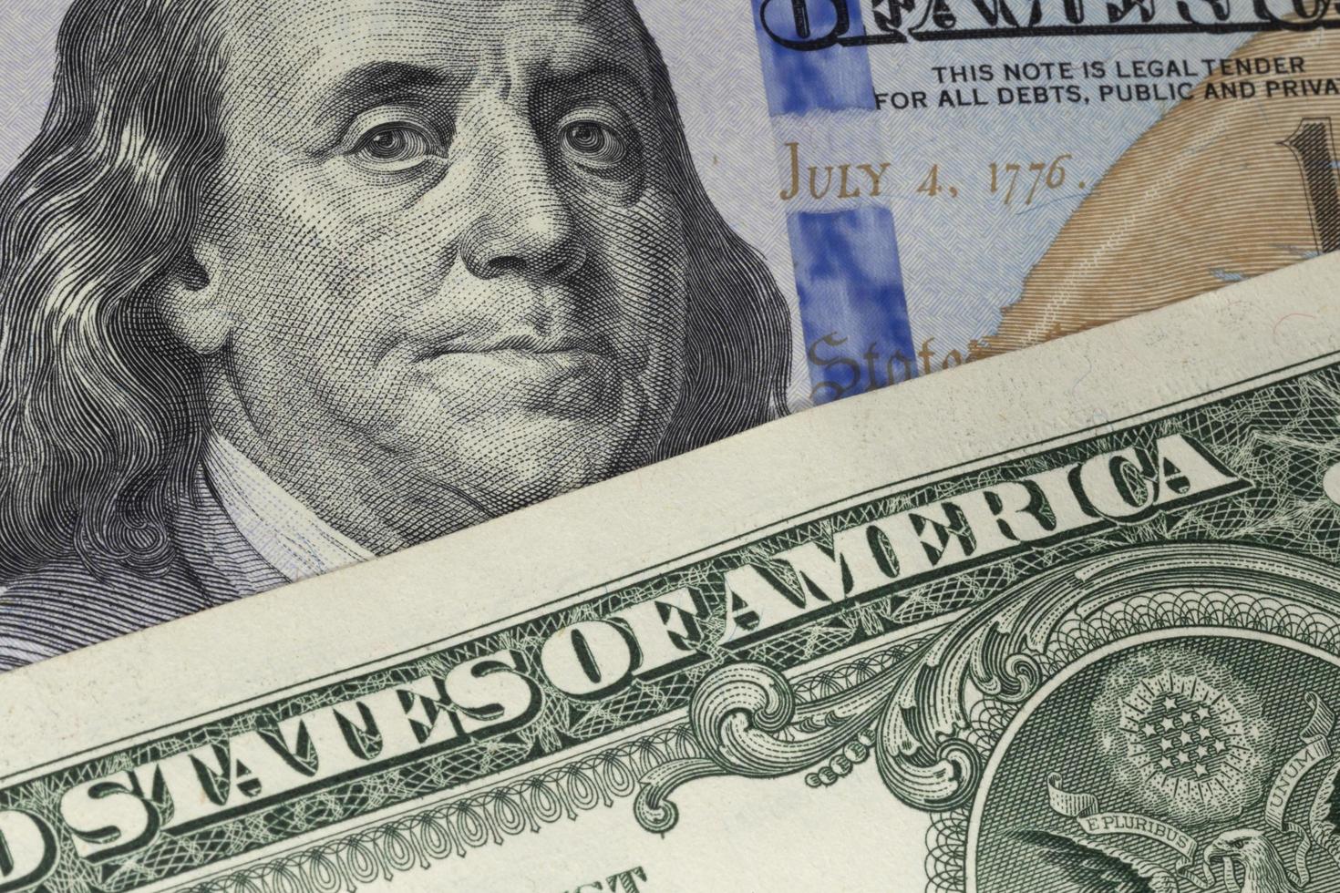 one US dollar banknote lying on 100 dollars banknote photo