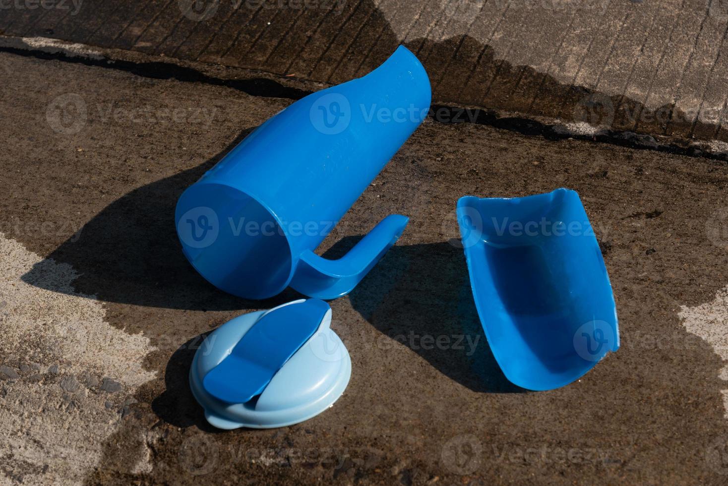 Broken plastic water bottle on wet floor photo