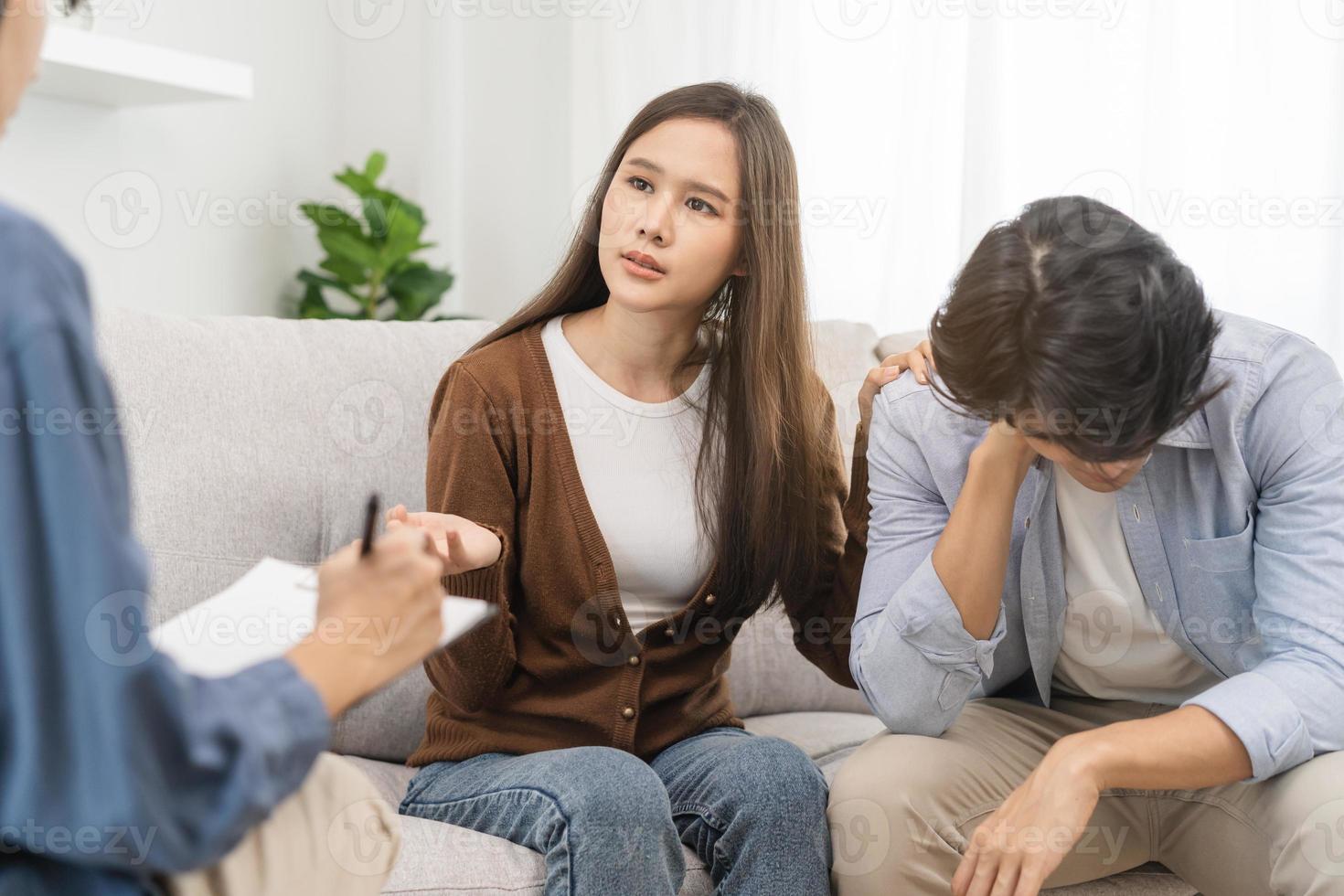 Psychology, depression asian young couple love, woman, man patient consulting problem mental health with psychologist, psychiatrist at clinic together, wife encouraging husband,  therapy health care. photo