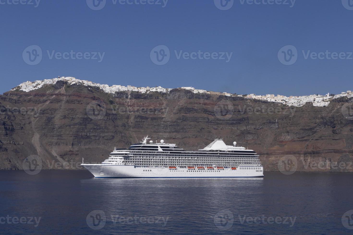 view of cruise ship in caldera of Santorini island photo