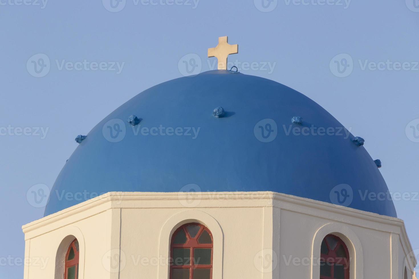 dome of chapel on Santorini island afainst clear blue sky photo