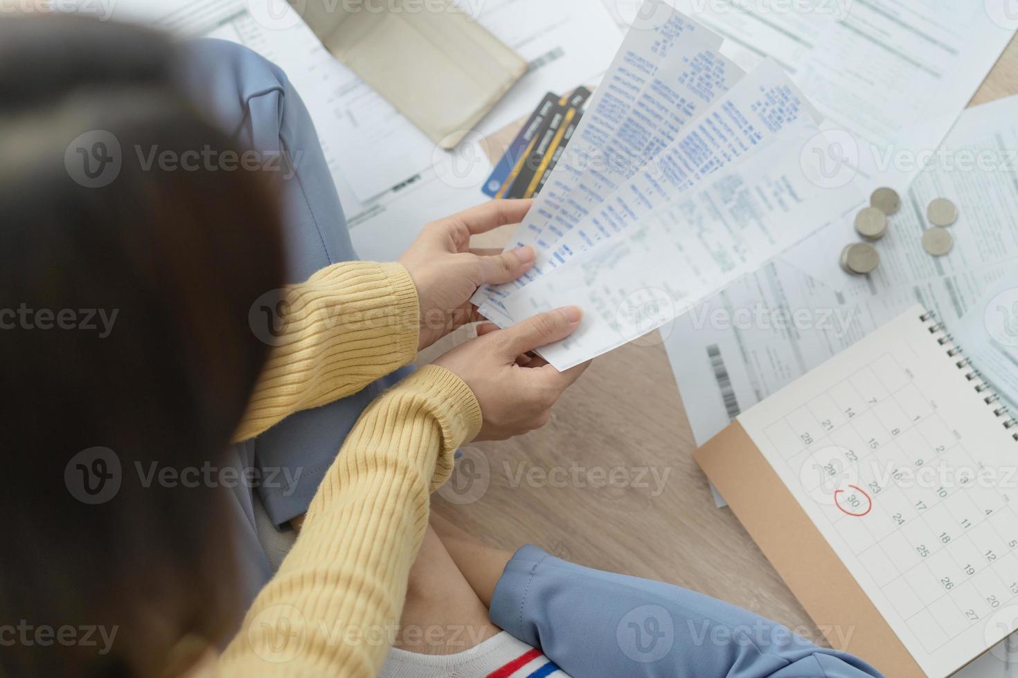 Financial owe asian woman, female sitting on floor home, stressed and confused by calculate expense from invoice or bill, have no money to pay, mortgage or loan. Debt, bankruptcy or bankrupt concept. photo