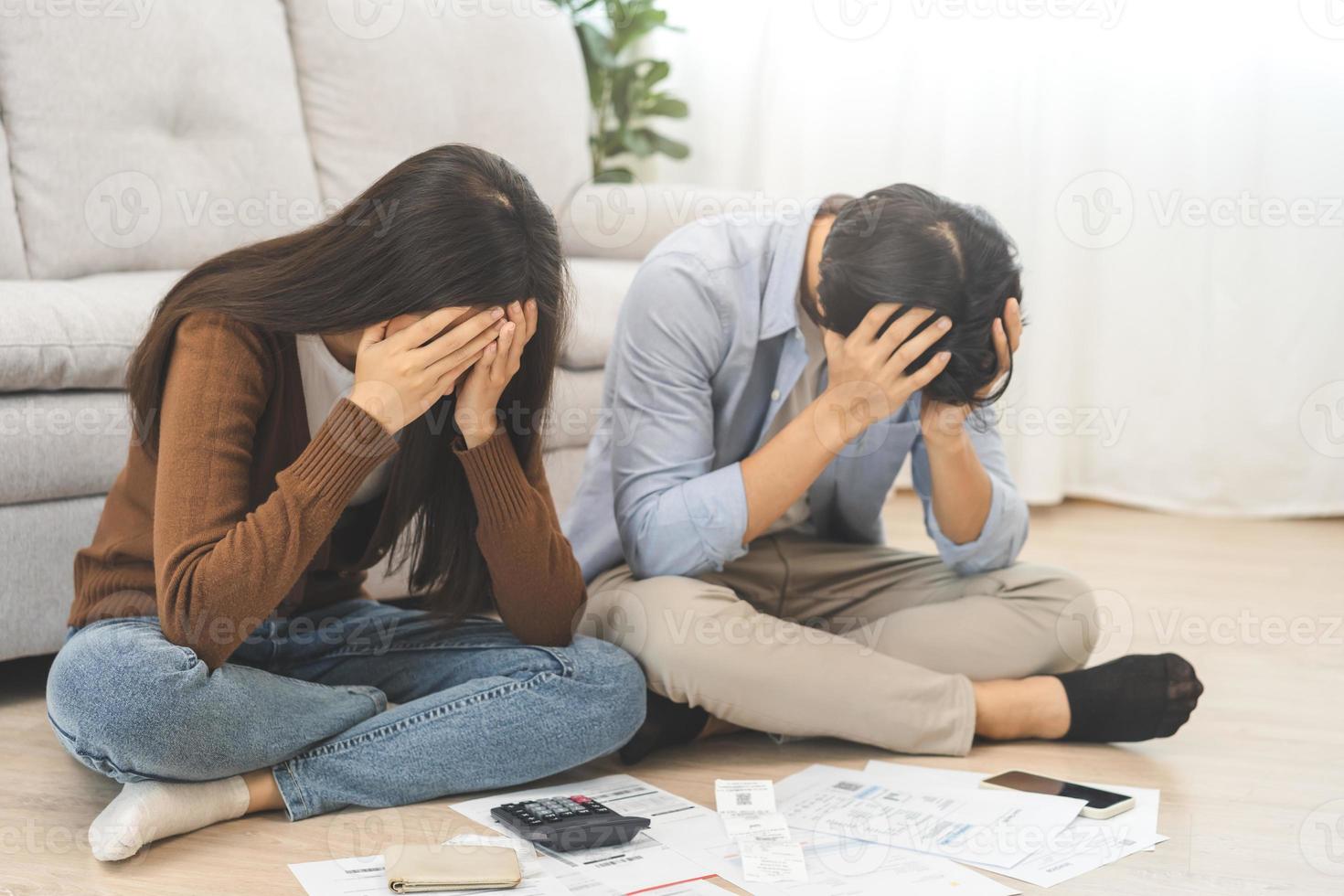 Stressed financial owe asian young couple love sitting suffer, stressed and confused by calculate expense from invoice or bill, no money to pay, mortgage or loan. Debt, bankrupt or bankruptcy people. photo