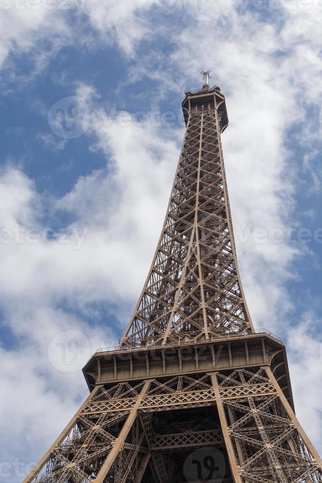 Eiffel tower in Paris against blue sky with white clouds photo