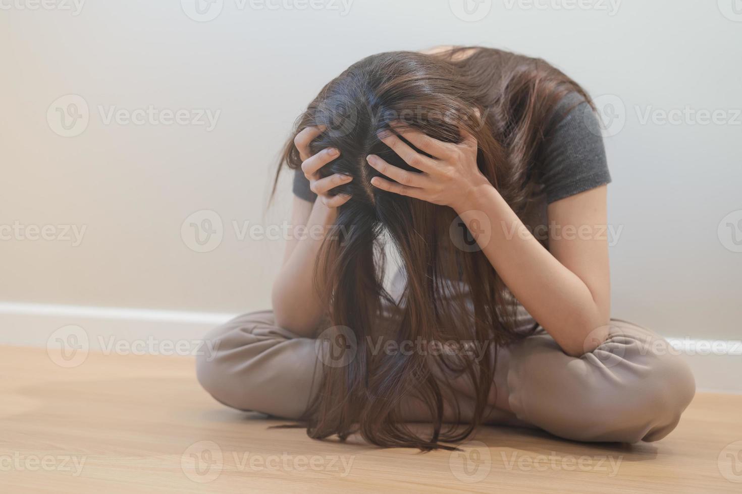 Psychological mental health, depressed asian young woman, girl hiding her face feeling lonely, thinking about problem, worried suffering depression, sitting alone on floor at home, depression people. photo