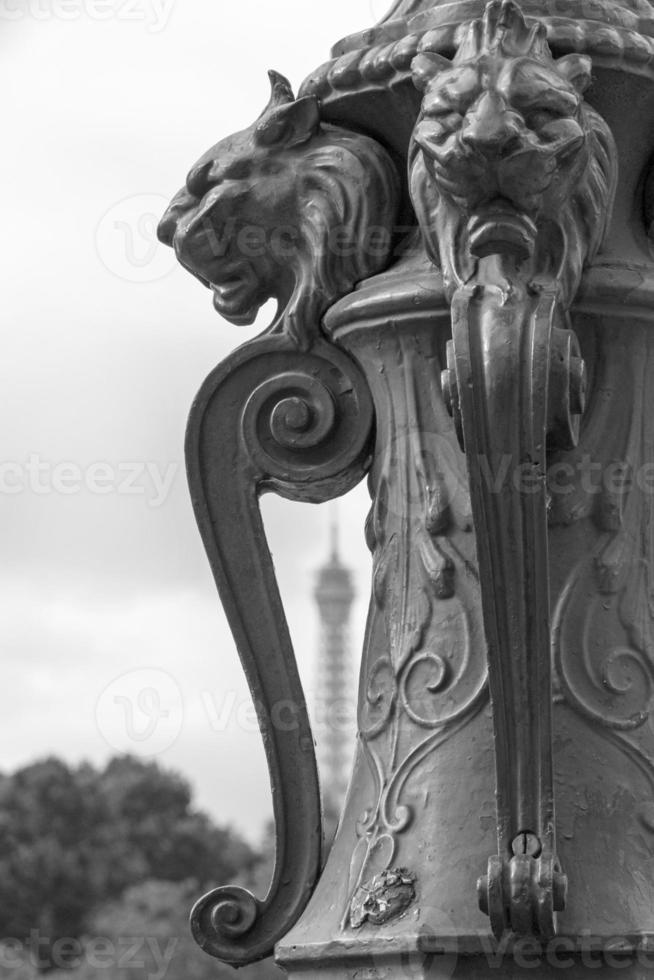 decoration on street lamp in Paris against Eiffel tower photo